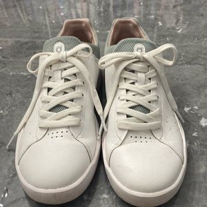 White sneakers trimmed in a light gray/green